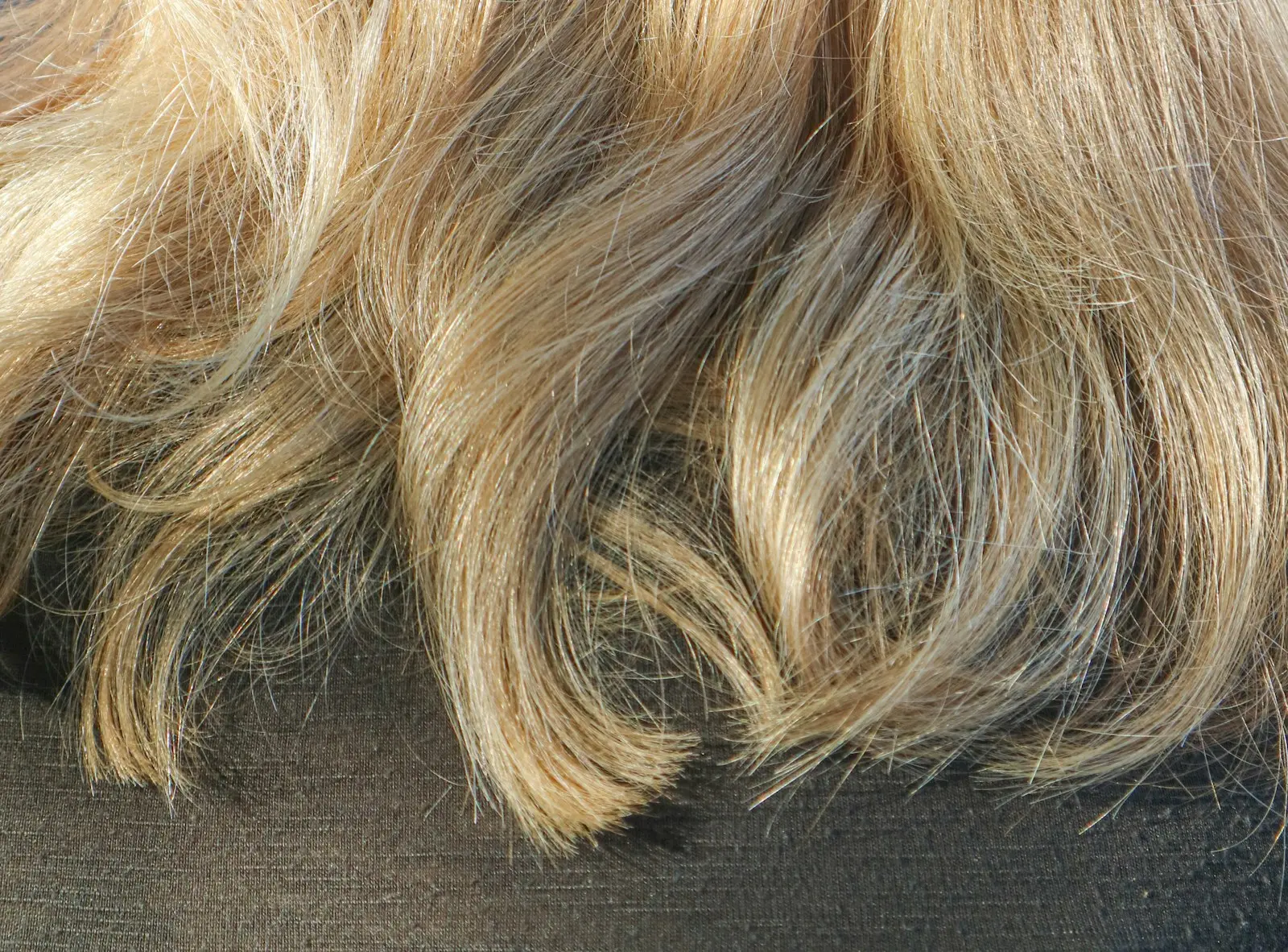 Honey-blonde balayage waves, hand-painted from a cool base to golden ends.